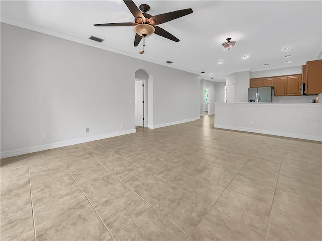 unfurnished living room with light tile patterned flooring, ceiling fan, and ornamental molding