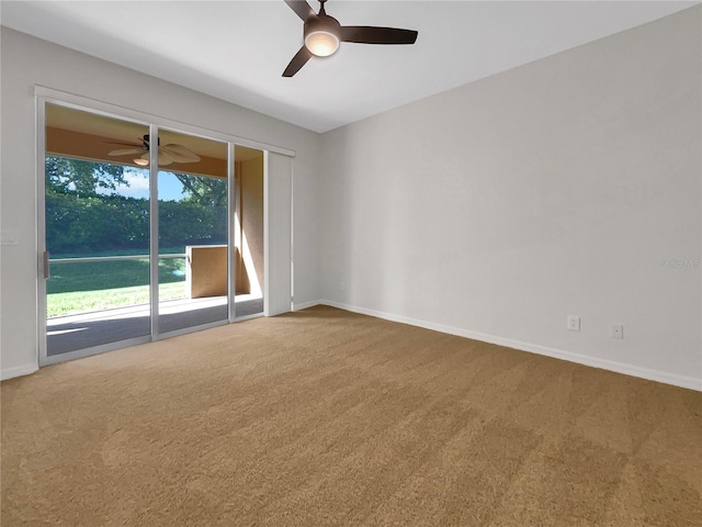 carpeted empty room featuring ceiling fan