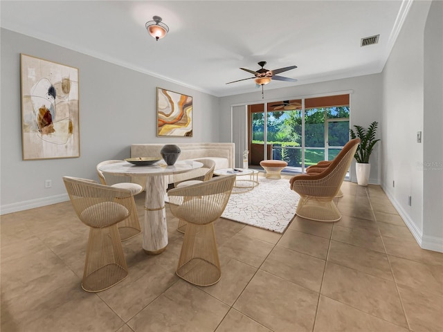 tiled dining room featuring ceiling fan and ornamental molding