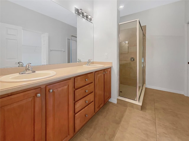 bathroom featuring tile patterned floors, an enclosed shower, and vanity