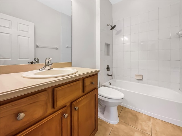 full bathroom with vanity, tiled shower / bath, tile patterned floors, and toilet