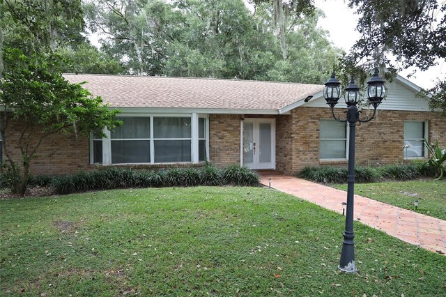 ranch-style home with a front lawn