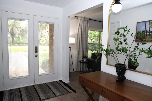 doorway featuring french doors, plenty of natural light, and light tile patterned flooring