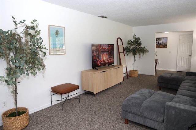 living room with dark carpet and a textured ceiling