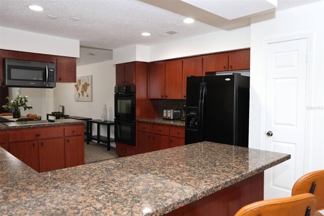 kitchen with a textured ceiling, black appliances, dark stone counters, backsplash, and kitchen peninsula