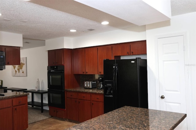 kitchen with black appliances, backsplash, light tile patterned floors, and a textured ceiling