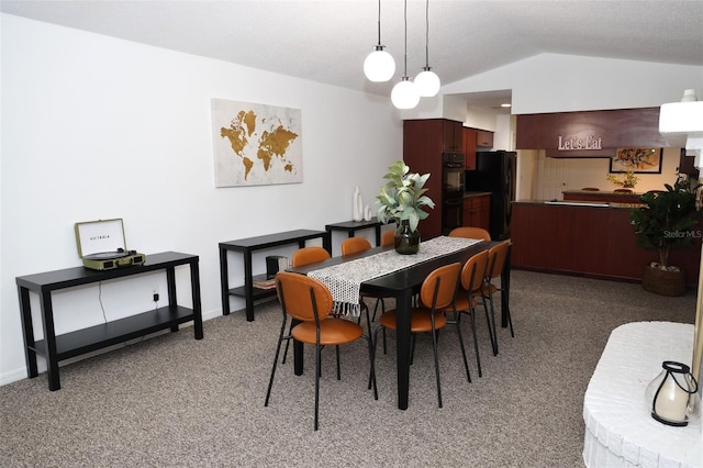 dining area with carpet flooring and vaulted ceiling