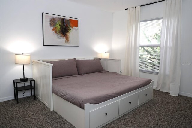 bedroom featuring dark colored carpet