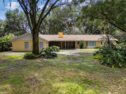 ranch-style home featuring a front yard