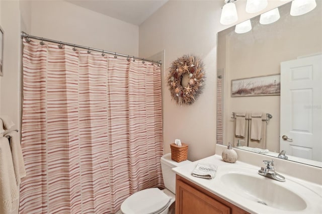 bathroom featuring a shower with shower curtain, vanity, and toilet