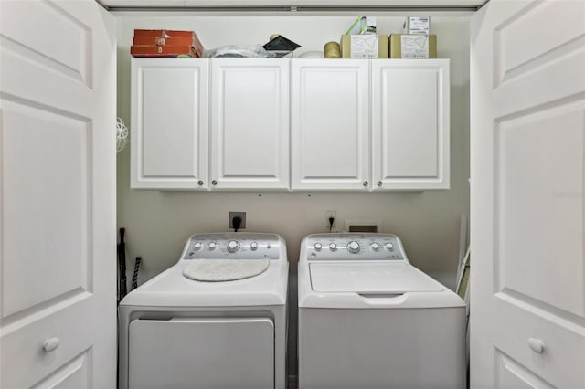 laundry area featuring cabinets and separate washer and dryer