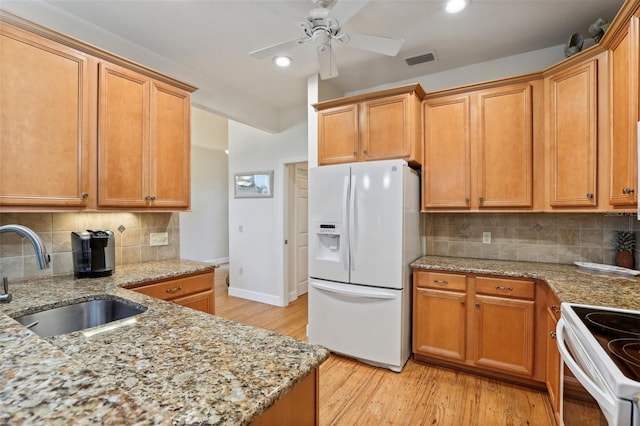 kitchen with ceiling fan, sink, white appliances, light hardwood / wood-style flooring, and backsplash