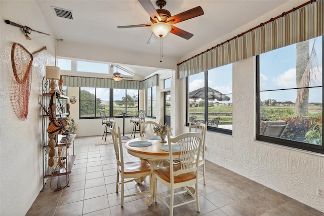 tiled dining room featuring ceiling fan