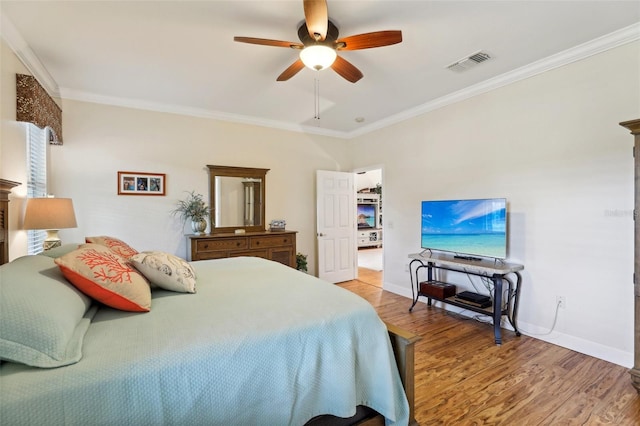 bedroom with ornamental molding, light wood-type flooring, and ceiling fan