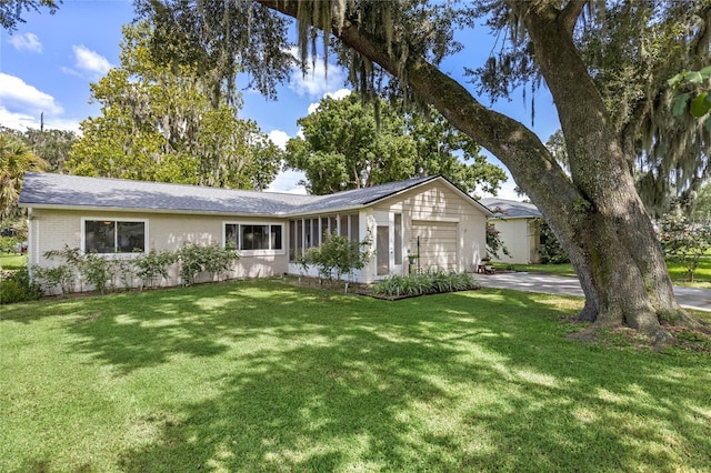 ranch-style home featuring a garage and a front yard