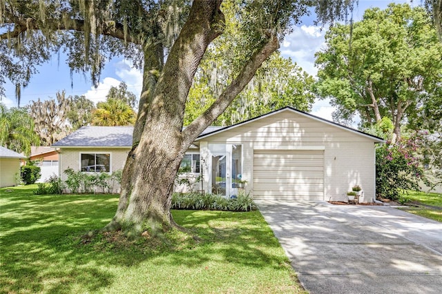 ranch-style home with a front lawn and a garage