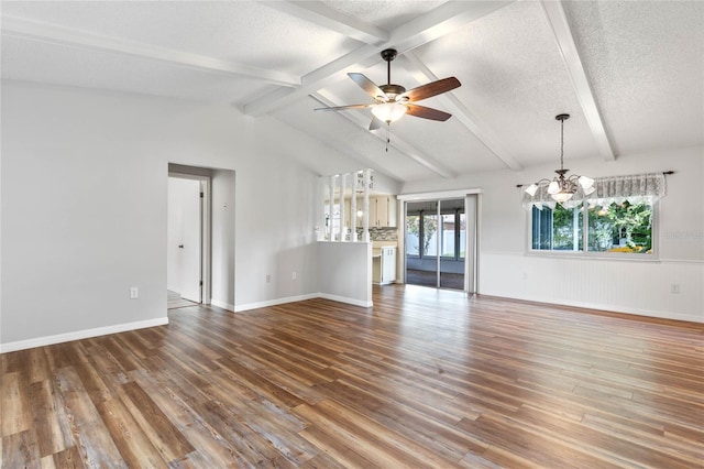 unfurnished living room featuring a textured ceiling, ceiling fan with notable chandelier, hardwood / wood-style flooring, and lofted ceiling with beams