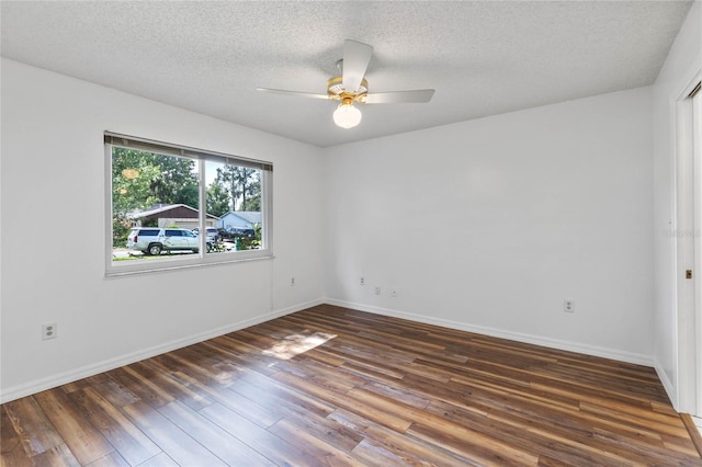 empty room with dark hardwood / wood-style flooring, ceiling fan, and a textured ceiling