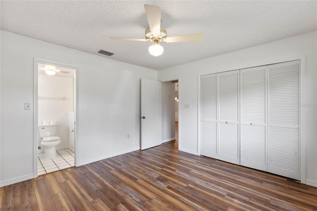 unfurnished bedroom with a closet, ceiling fan, and dark hardwood / wood-style floors