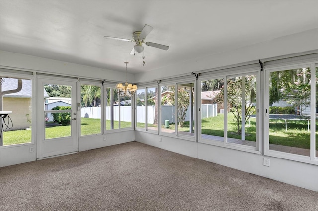 unfurnished sunroom with ceiling fan