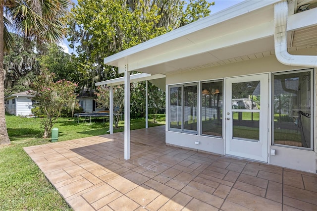 view of patio featuring a storage unit and a trampoline