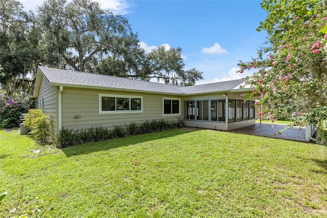 view of front of home featuring a sunroom and a front lawn