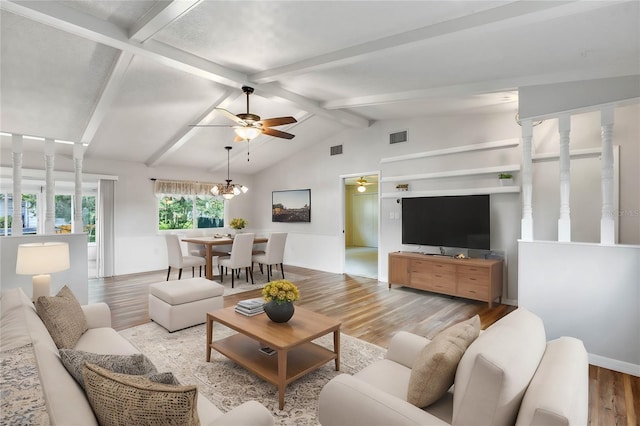 living room with lofted ceiling with beams, hardwood / wood-style flooring, and ceiling fan