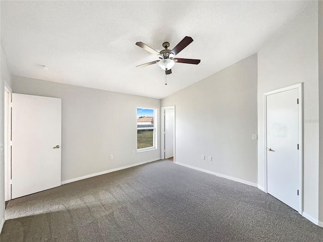 carpeted empty room with ceiling fan and vaulted ceiling