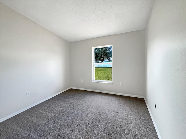 carpeted spare room featuring a textured ceiling