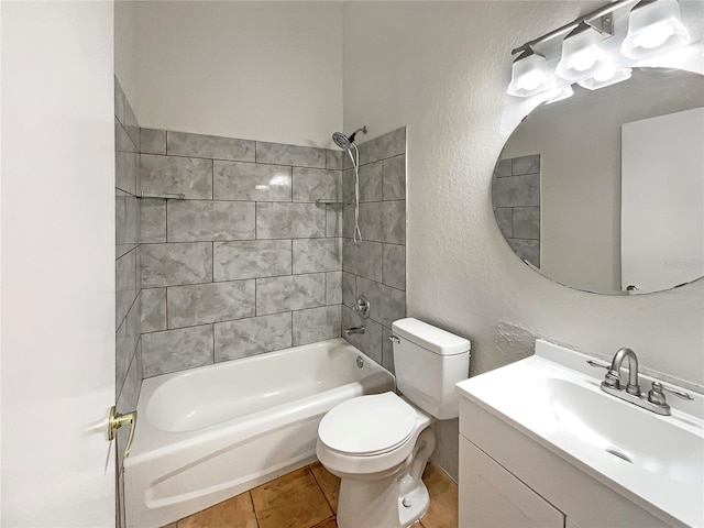 full bathroom featuring tile patterned floors, tiled shower / bath combo, toilet, and vanity