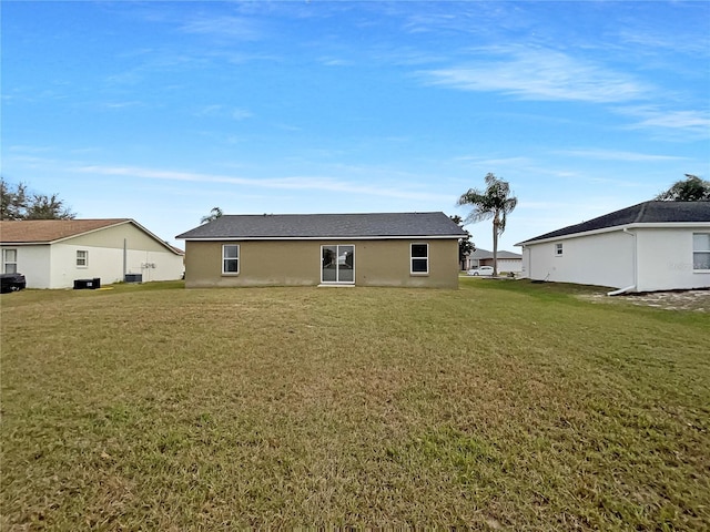 back of property featuring a lawn