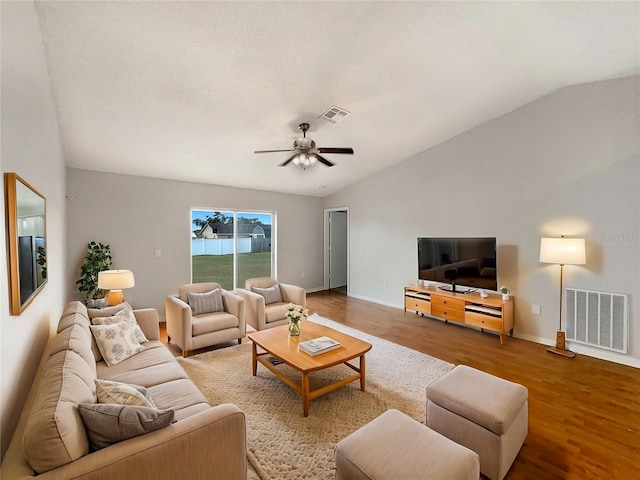 living room with ceiling fan, wood-type flooring, and vaulted ceiling