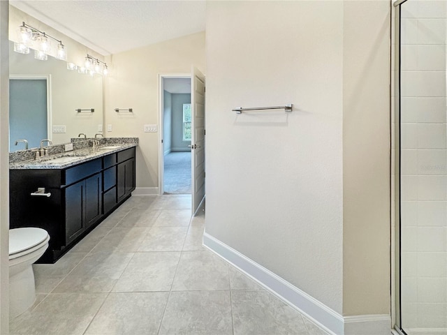 bathroom featuring a textured ceiling, lofted ceiling, tile patterned floors, vanity, and toilet