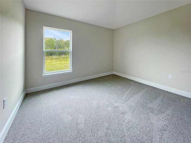 unfurnished room featuring baseboards and carpet flooring