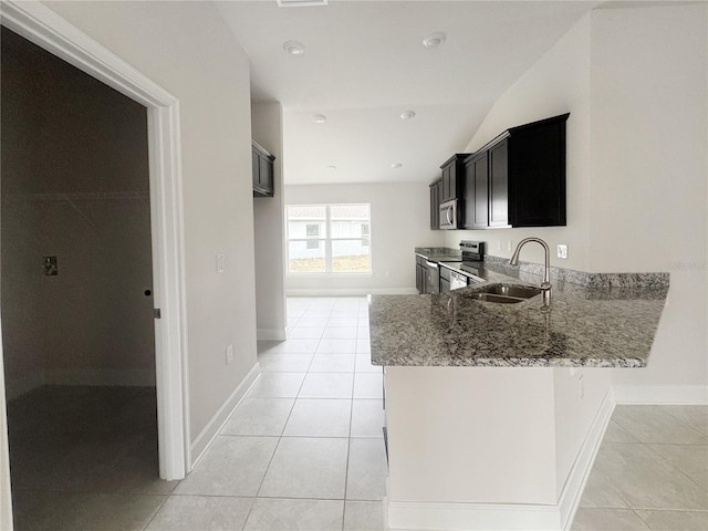 kitchen featuring light stone countertops, light tile patterned floors, stainless steel appliances, and sink