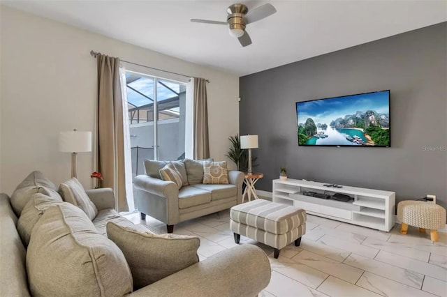 living area with a ceiling fan and marble finish floor