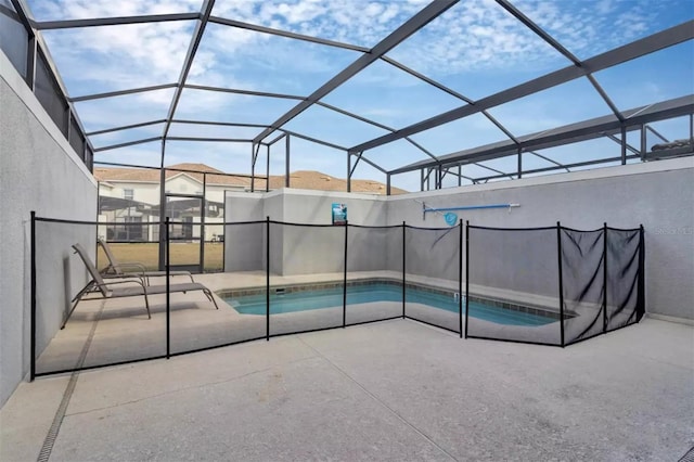 view of swimming pool with a fenced in pool, glass enclosure, and a patio area