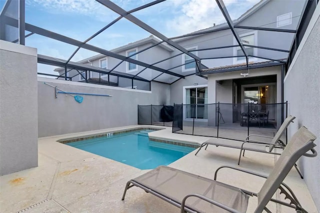 view of pool featuring a patio area and glass enclosure