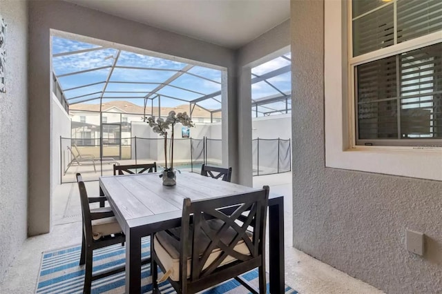exterior space featuring outdoor dining space and glass enclosure