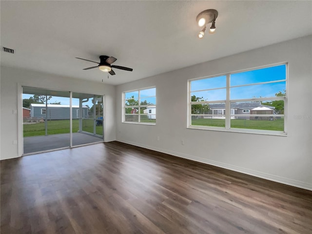 empty room featuring ceiling fan and dark hardwood / wood-style flooring