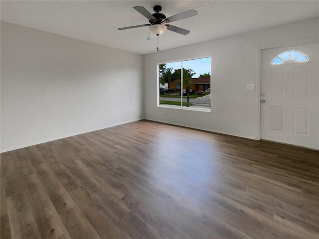 foyer entrance featuring dark hardwood / wood-style floors, a textured ceiling, and ceiling fan