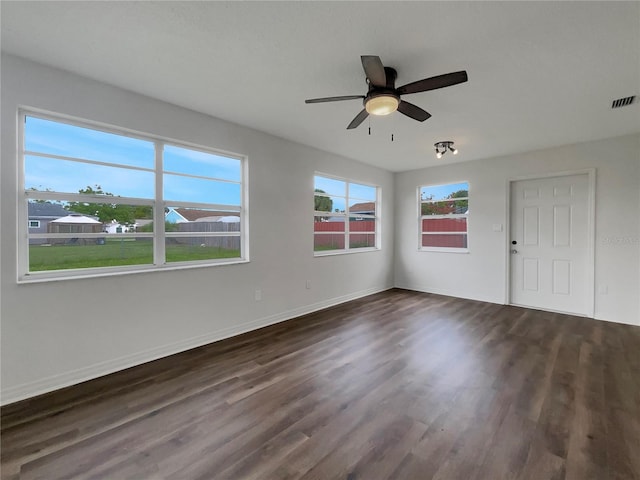 unfurnished room featuring dark wood-type flooring and ceiling fan