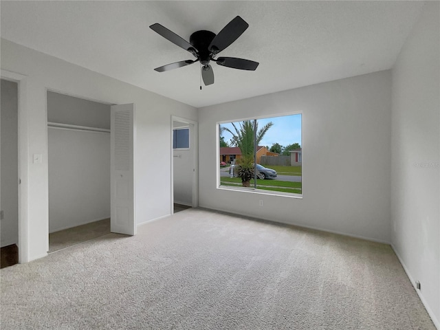 unfurnished bedroom with light colored carpet and ceiling fan