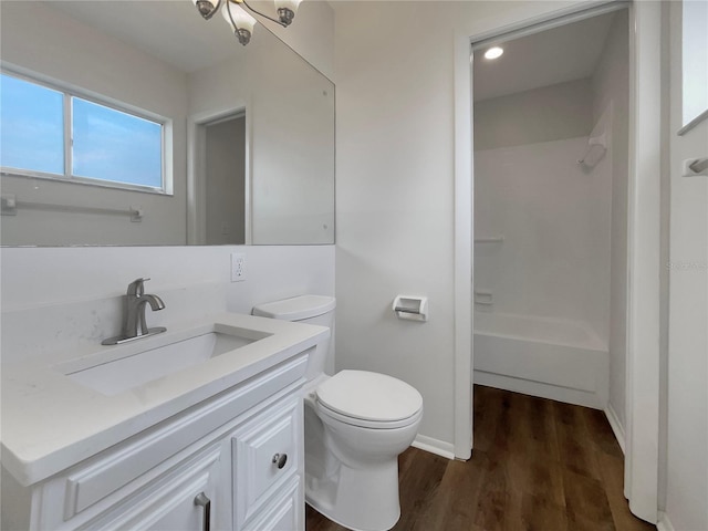 full bathroom featuring shower / tub combination, vanity, hardwood / wood-style floors, and toilet