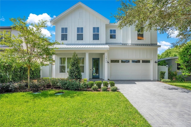 view of front facade with a garage and a front lawn