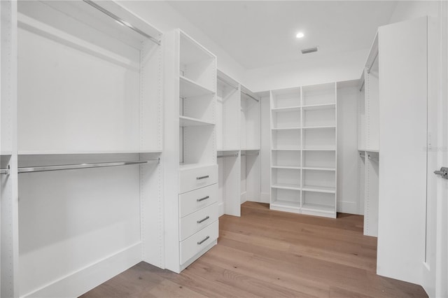 spacious closet with light hardwood / wood-style flooring