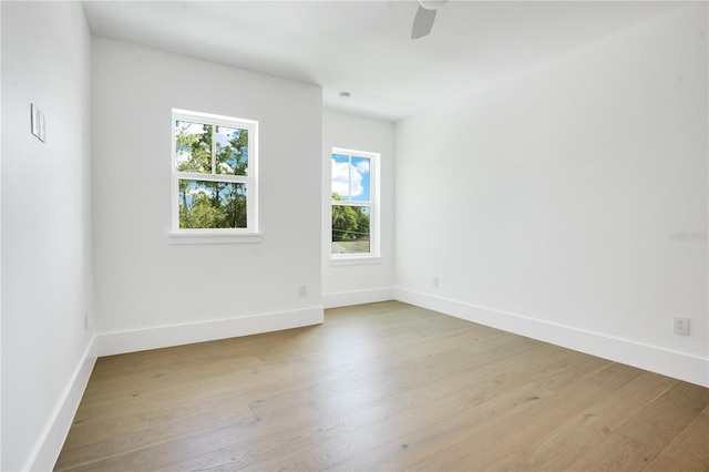 spare room with ceiling fan and light wood-type flooring