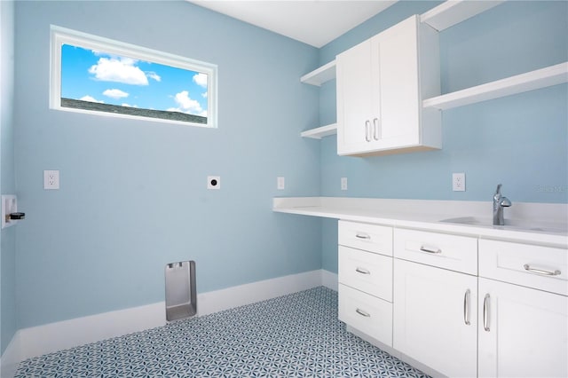 laundry room featuring cabinets, sink, and hookup for an electric dryer