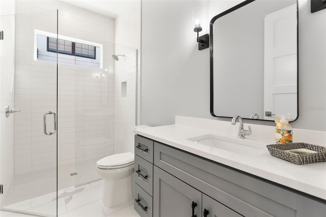 bathroom with vanity, toilet, and an enclosed shower