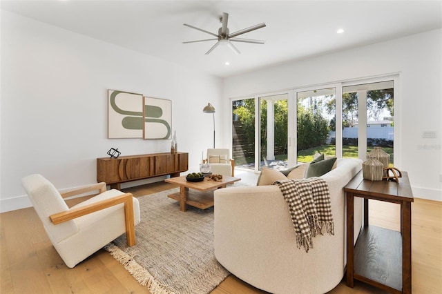 living room featuring hardwood / wood-style floors and ceiling fan